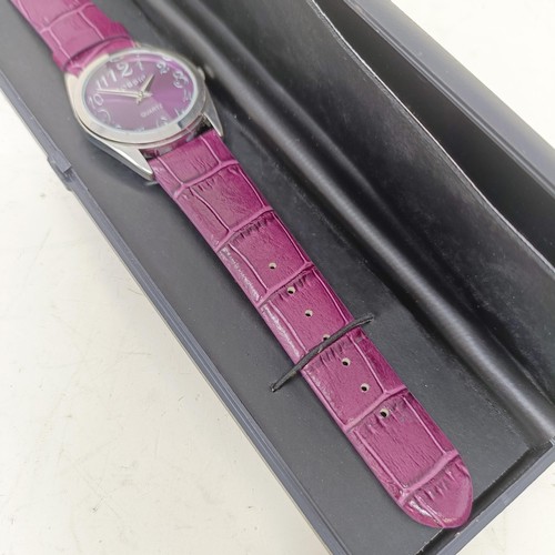 18 - A plum coloured Gossip wristwatch, with quartz movement, functioning and boxed