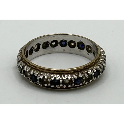 33 - A white stone and sapphire eternity ring, ring size N, in a modern ring box