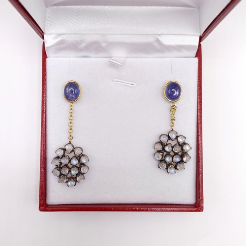 39 - A pair of silver gilt articulated long drop earrings, set with oval cabochon sapphires, and vari-cut... 