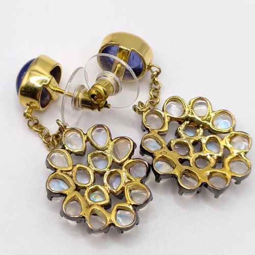 39 - A pair of silver gilt articulated long drop earrings, set with oval cabochon sapphires, and vari-cut... 