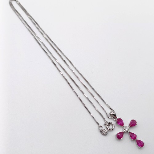 46 - A 9ct white gold pear-shaped ruby and diamond cross on a silver chain, boxed, rubies 2.45ct approx.,... 