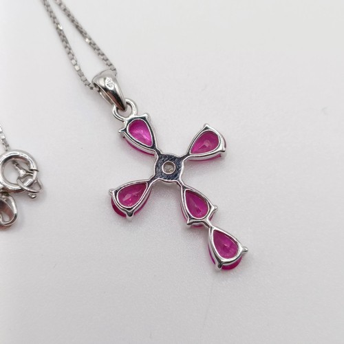 46 - A 9ct white gold pear-shaped ruby and diamond cross on a silver chain, boxed, rubies 2.45ct approx.,... 