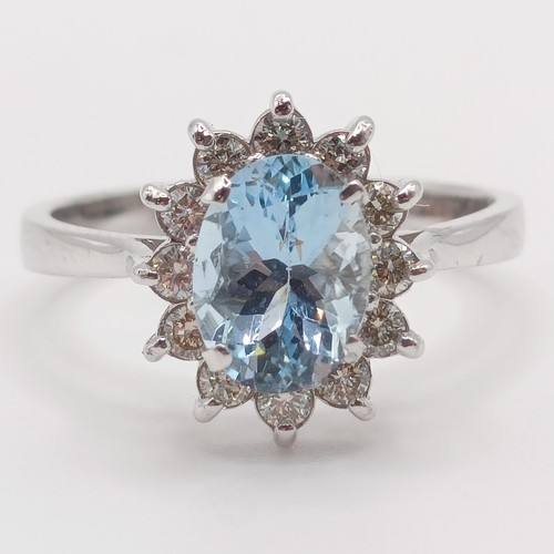 56 - A 18ct white gold, oval aquamarine and RBC diamond cluster ring, aquamarine 0.80ct, diamonds 0.30ct