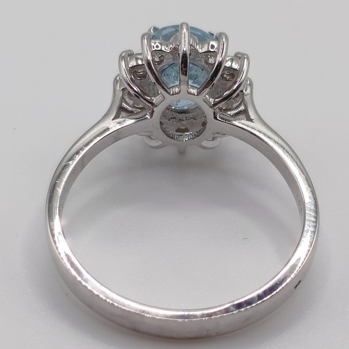 56 - A 18ct white gold, oval aquamarine and RBC diamond cluster ring, aquamarine 0.80ct, diamonds 0.30ct