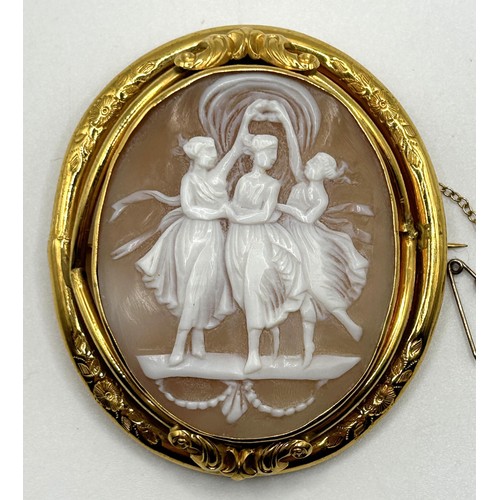 59 - A late 19th/early 20th century cameo, decorated three dancing figures, in a yellow coloured metal mo... 