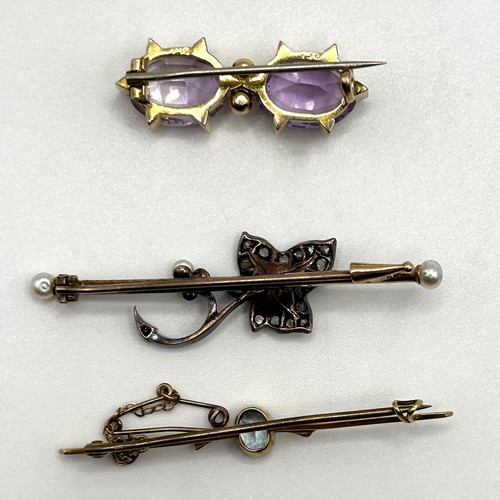 60 - A 9ct gold and purple stone bar brooch, and two other bar brooches (3)