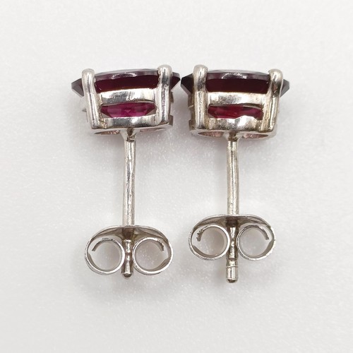 62 - A pair of rhodolite garnet studs, in silver