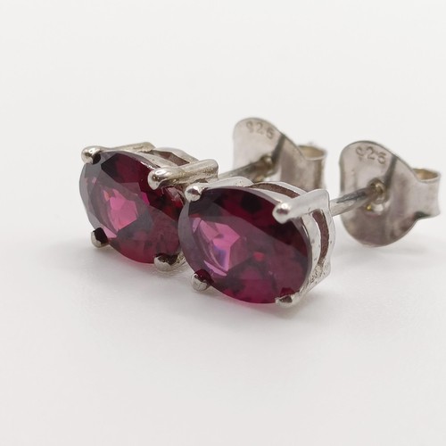 62 - A pair of rhodolite garnet studs, in silver