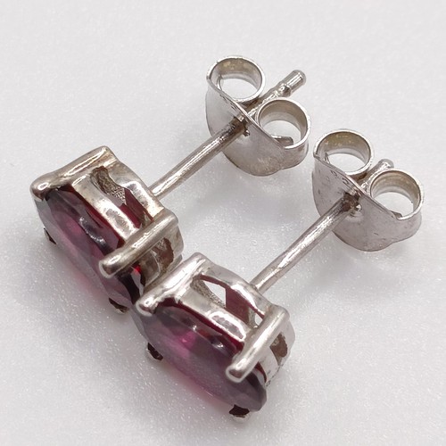 62 - A pair of rhodolite garnet studs, in silver