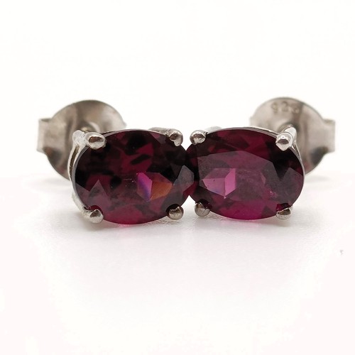 62 - A pair of rhodolite garnet studs, in silver