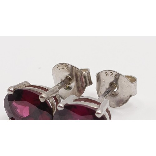 62 - A pair of rhodolite garnet studs, in silver