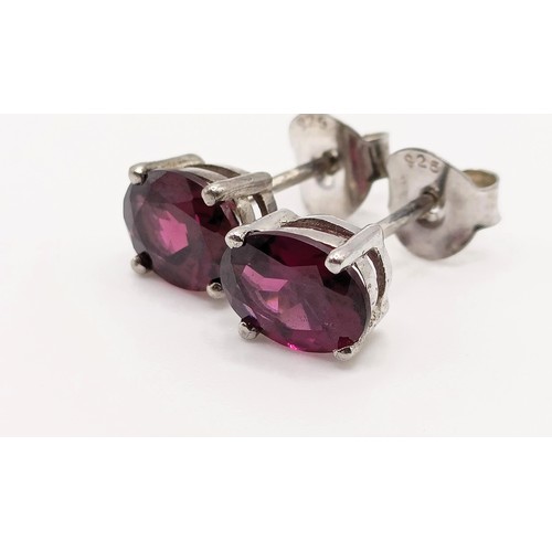 62 - A pair of rhodolite garnet studs, in silver