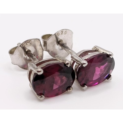 62 - A pair of rhodolite garnet studs, in silver