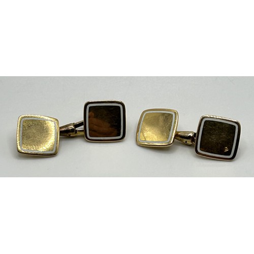 67 - A pair of 18ct gold and white enamel cufflinks, all in 11.9 g