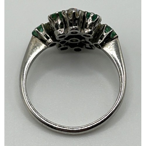 68 - A platinum, diamond and emerald cluster ring, ring size N