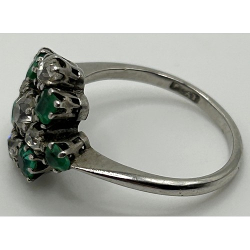 68 - A platinum, diamond and emerald cluster ring, ring size N