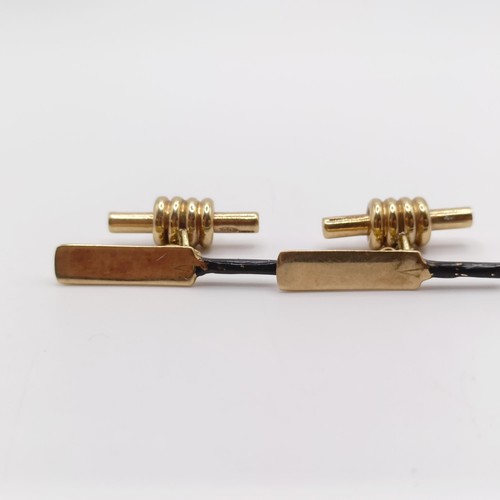 69 - A pair of 9ct gold and enamel novelty cufflinks, in the form of cricket bats and bails