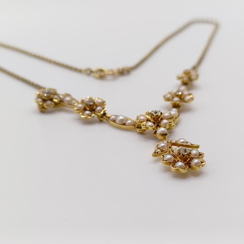 75 - An early 20th century 15ct gold and seed pearl floral necklace