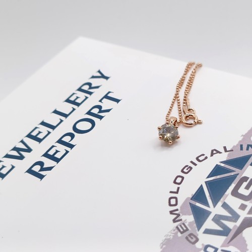 77 - A certificated 18ct rose gold and RBC diamond solitaire pendant, on a rose gold-plated silver chain,... 