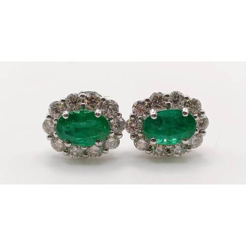 83 - A pair of 18ct white gold, oval emerald and RBC diamond cluster studs, boxed, emeralds 0.58ct, RBC d... 