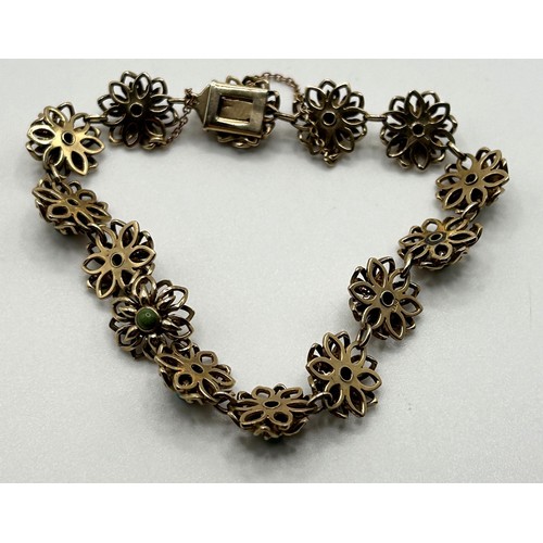 85 - A yellow coloured metal and turquoise bracelet, decorated flower heads,