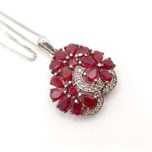 90 - A foliate silver pendant, set with pear-shaped rubies and R/C white sapphires on a silver chain, rub... 