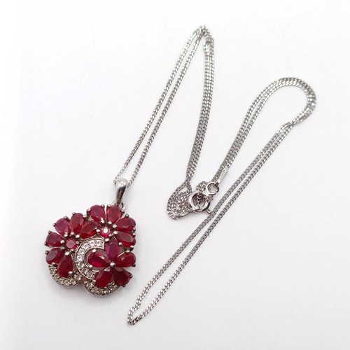 90 - A foliate silver pendant, set with pear-shaped rubies and R/C white sapphires on a silver chain, rub... 