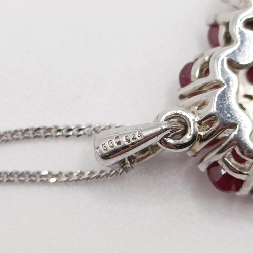 90 - A foliate silver pendant, set with pear-shaped rubies and R/C white sapphires on a silver chain, rub... 