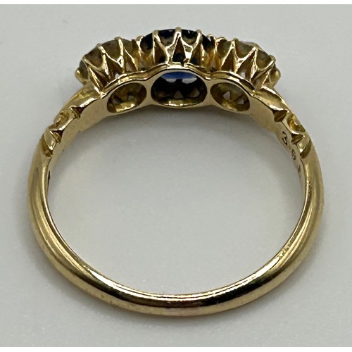 97 - An 18ct gold, diamond and blue stone three stone ring, ring size O