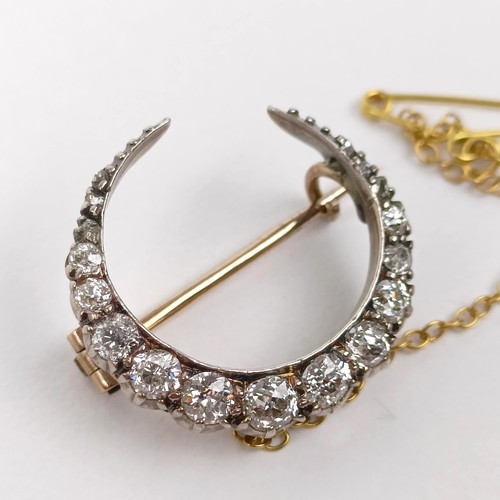 98 - An early 20th century diamond crescent brooch, all in 2.7 g