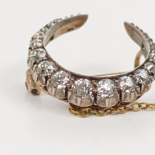 98 - An early 20th century diamond crescent brooch, all in 2.7 g