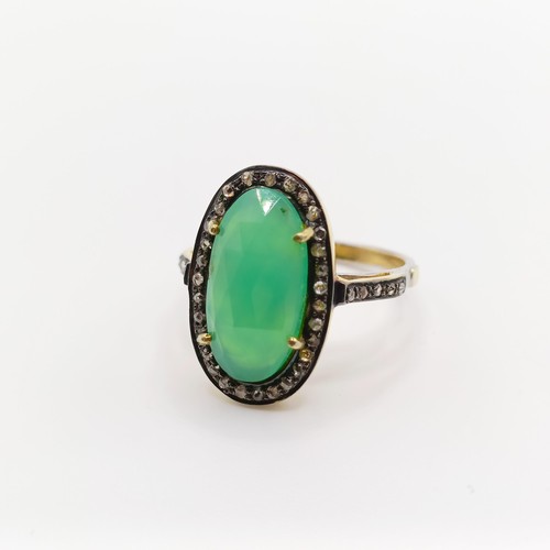 101 - A dress ring set with a central chrysoprase and rose-cut diamonds in silver gilt, oval cabochon chry... 