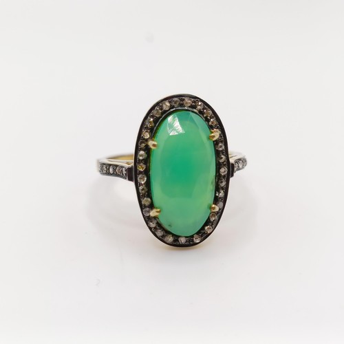 101 - A dress ring set with a central chrysoprase and rose-cut diamonds in silver gilt, oval cabochon chry... 