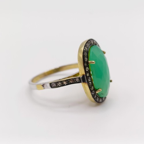 101 - A dress ring set with a central chrysoprase and rose-cut diamonds in silver gilt, oval cabochon chry... 