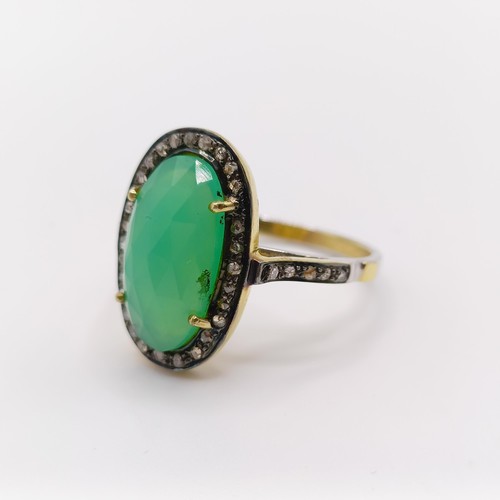 101 - A dress ring set with a central chrysoprase and rose-cut diamonds in silver gilt, oval cabochon chry... 