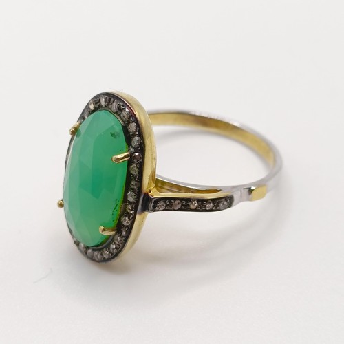 101 - A dress ring set with a central chrysoprase and rose-cut diamonds in silver gilt, oval cabochon chry... 