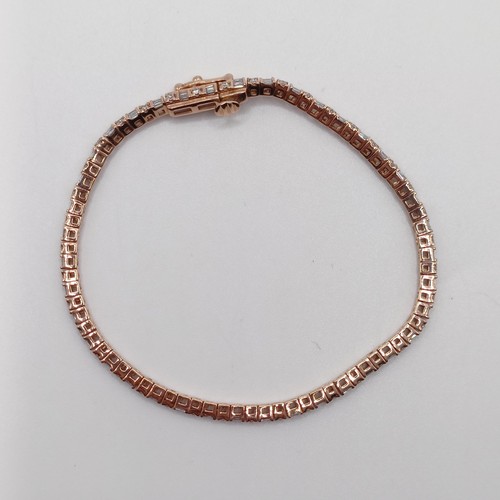 107 - An unusual 10ct rose gold bracelet, set with baguette and RBC diamonds, with an open box clasp and s... 