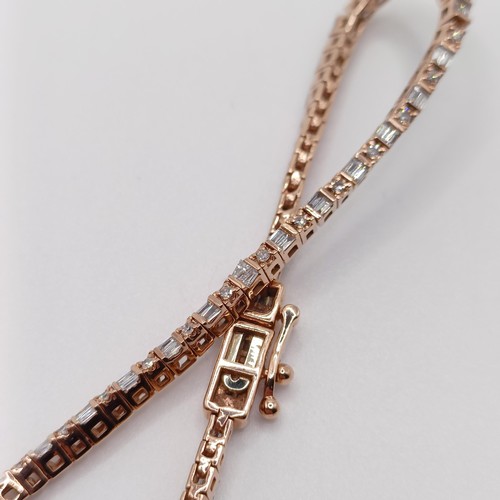 107 - An unusual 10ct rose gold bracelet, set with baguette and RBC diamonds, with an open box clasp and s... 