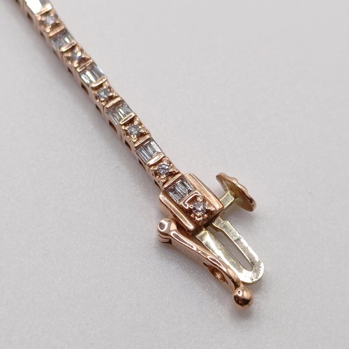 107 - An unusual 10ct rose gold bracelet, set with baguette and RBC diamonds, with an open box clasp and s... 