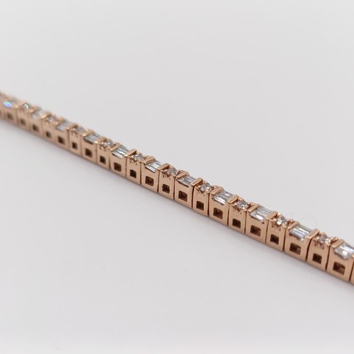 107 - An unusual 10ct rose gold bracelet, set with baguette and RBC diamonds, with an open box clasp and s... 