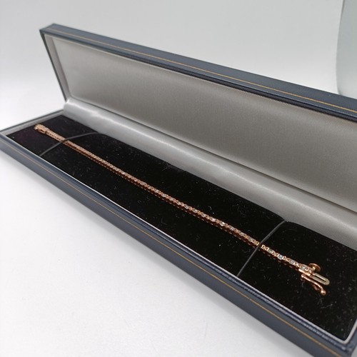 107 - An unusual 10ct rose gold bracelet, set with baguette and RBC diamonds, with an open box clasp and s... 