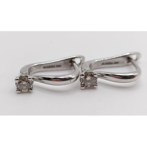 117 - A pair of 14ct white gold and diamond earrings