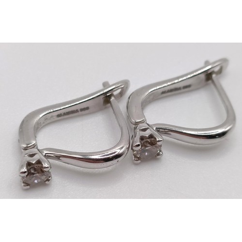 117 - A pair of 14ct white gold and diamond earrings