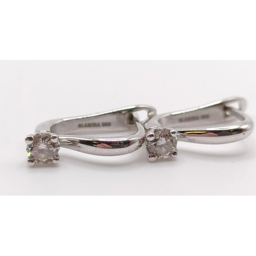 117 - A pair of 14ct white gold and diamond earrings