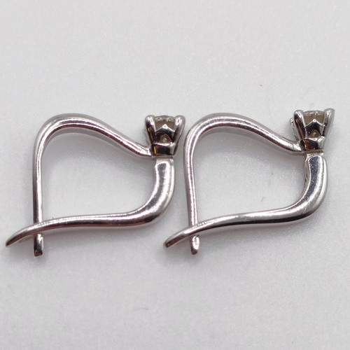 117 - A pair of 14ct white gold and diamond earrings