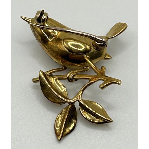 124 - A yellow coloured metal brooch, in the form of a wren perched upon a twig, 3 cm wide