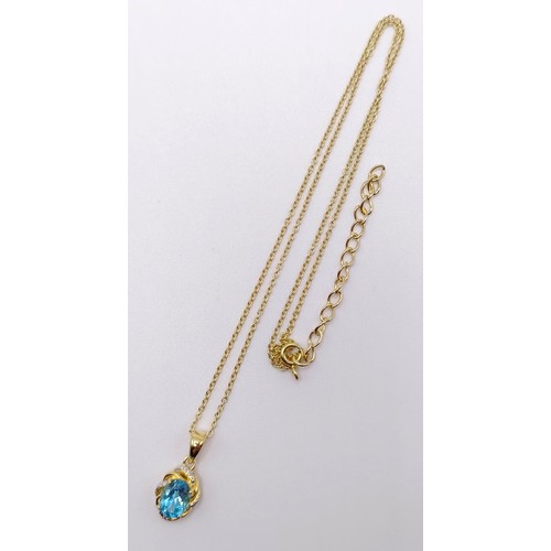 127 - A gold plated silver chain and pendant, set with an oval Swiss blue topaz and diamonds