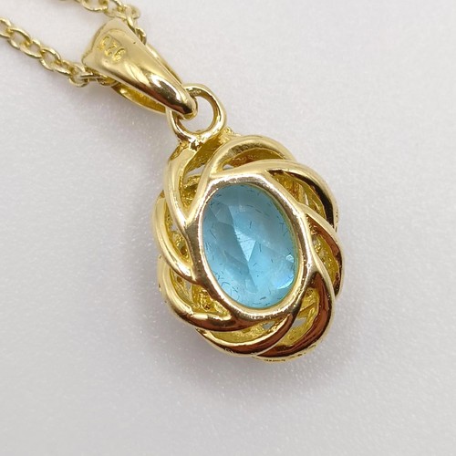 127 - A gold plated silver chain and pendant, set with an oval Swiss blue topaz and diamonds