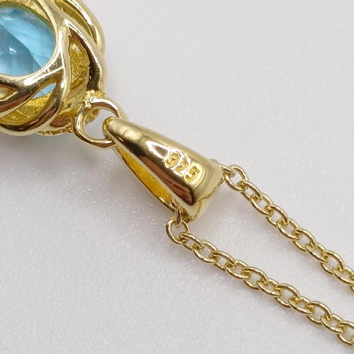 127 - A gold plated silver chain and pendant, set with an oval Swiss blue topaz and diamonds