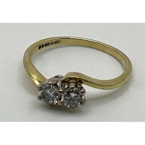 136 - An 18ct gold and diamond crossover ring, ring size M